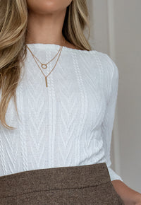 Women’s Aniz ivory textured cable-knit top with boat neckline and three-quarter sleeves by Elizabeth Lozano.